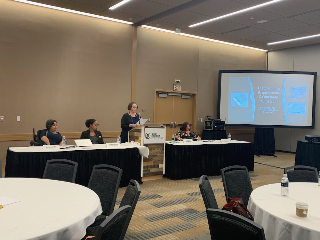 Picture of people speaking at a conference