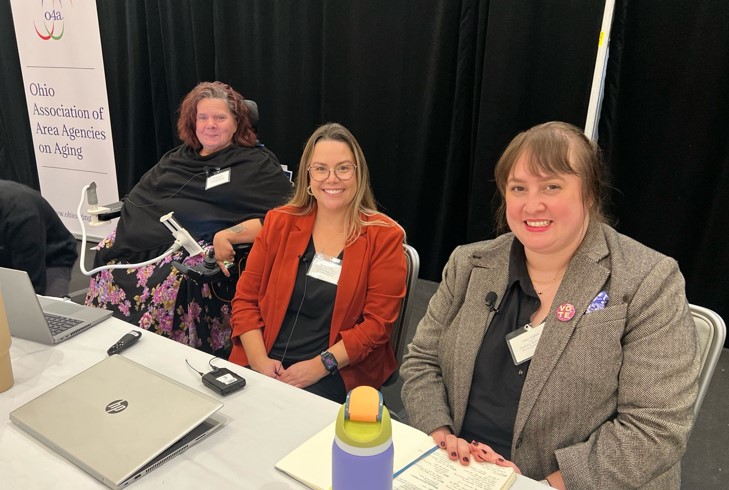 Photo of conference attendees seated at table.